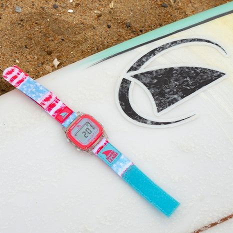 Limited-edition Shark Watch featuring red, white, and blue design on a surfboard background.