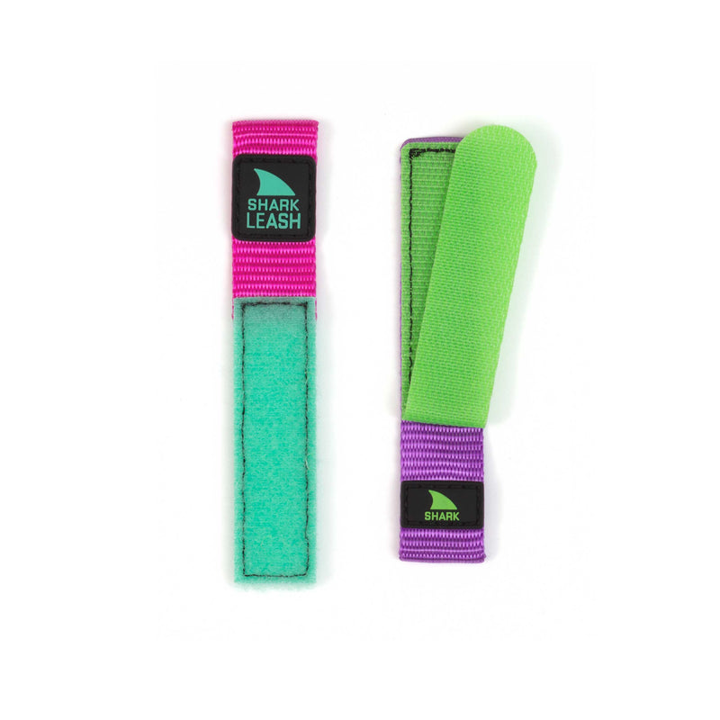 Two vibrant Freestyle STRAP KIT - LEASH - MASQUERADE straps display green, pink, and purple fabric along with the leash closure.