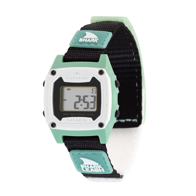 A Freestyle SHARK MINI LEASH MINT watch with a black strap and mint accents, its digital display lit with numbers.
