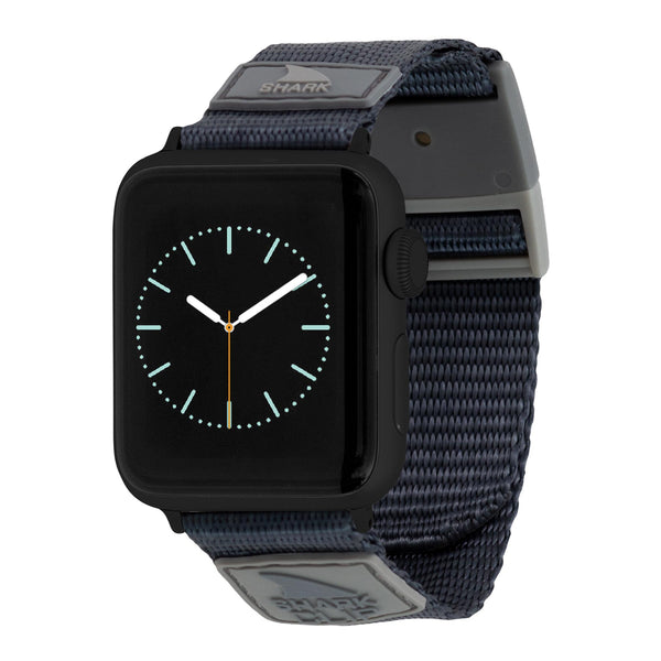 APPLE WATCH™ featuring a black face and a blue Shark Clip Strap by Freestyle, with minimalist hands and markers.