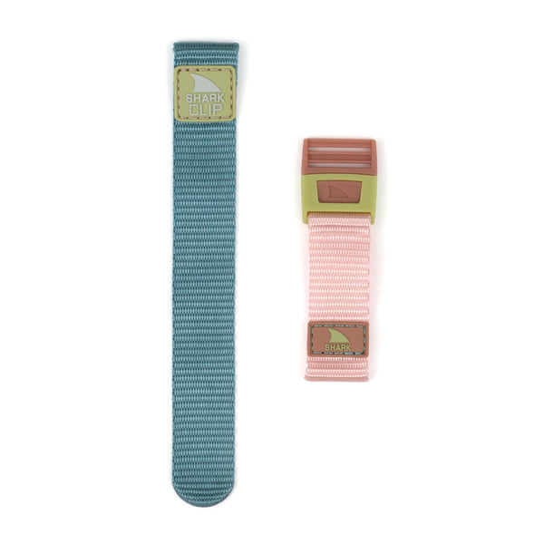 Two shark-themed APPLE WATCH™ CLIP STRAP CABO bands by Freestyle: one long teal strap with brown shark motifs, and one short pink strap featuring brown shark motifs.