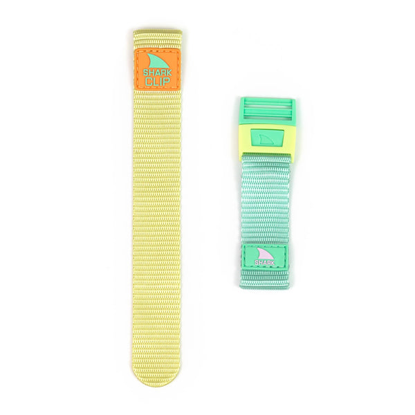 Two Freestyle strap kits: one in Daffodil color with a SHARK CLIP label, and the other in green and blue featuring a shark logo.