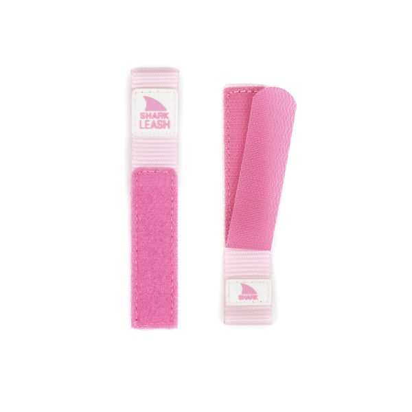 Two Freestyle APPLE WATCH™ LEASH STRAP PINK CRUSH bands with white labels, placed next to each other on a white background.