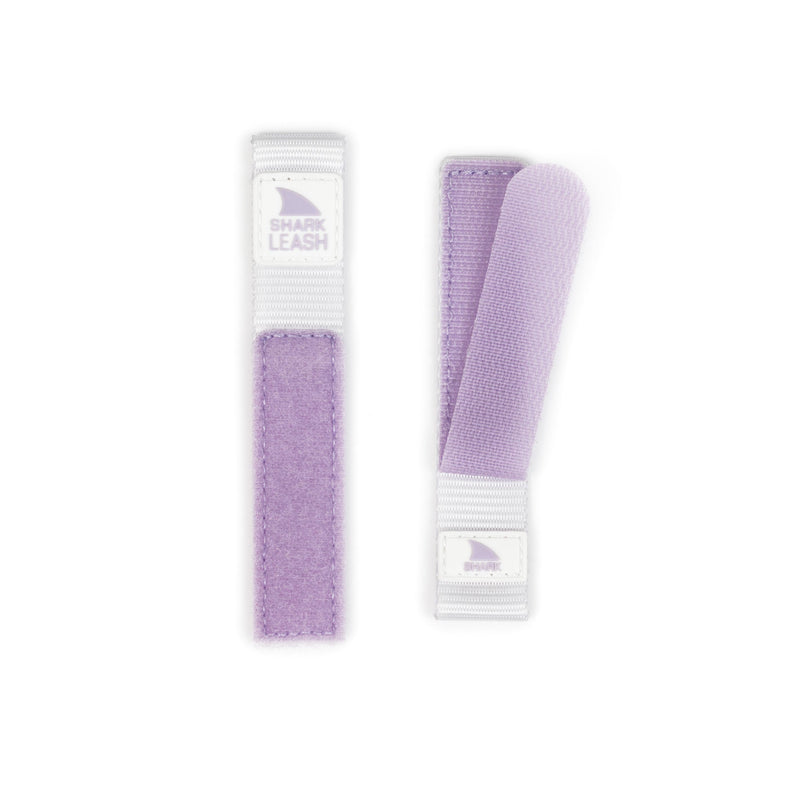 Two Freestyle APPLE WATCH™ LEASH STRAP LILAC SPLASH bands, one lying flat and one folded, on a white background.