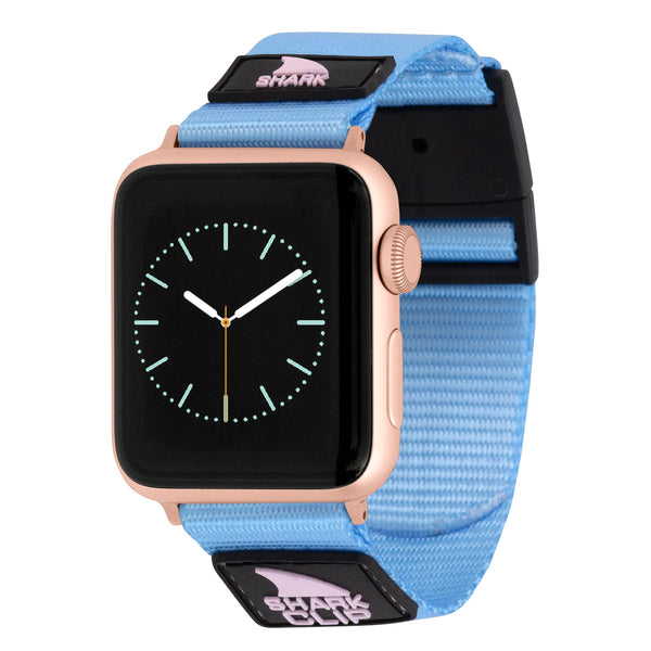 APPLE WATCH™ with analog display, pink case, and acai berry fabric strap by Freestyle featuring a shark logo.