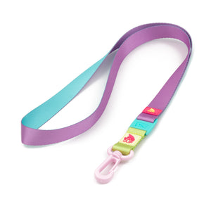 The Freestyle Sour Apple Lanyard & Key Chain features a vibrant design with a purple strap and a light pink Shark Clip.