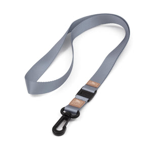 The Freestyle Sahara Lanyard & Key Chain features a gray nylon loop, Shark Clip, black buckle, and brown leather accents.