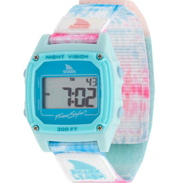 A Freestyle Shark Classic digital wristwatch with a tie dye pastel leash strap, display shows numbers.