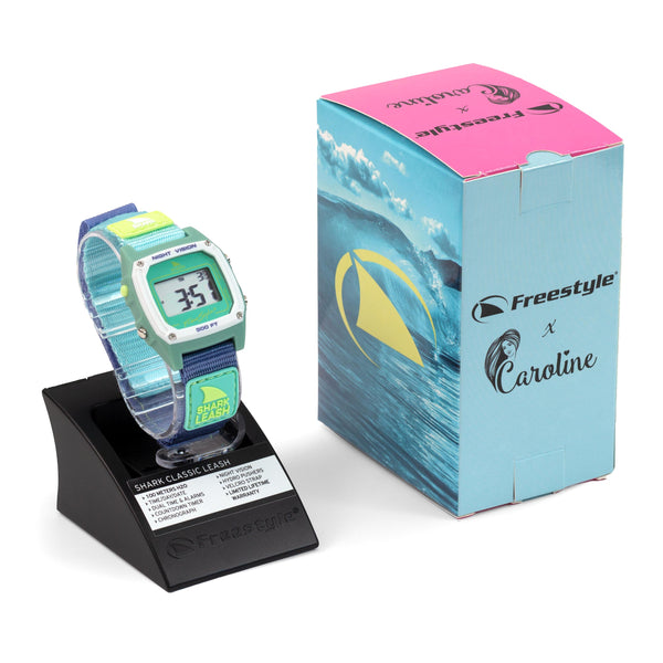 Caroline Marks Signature Freestyle Shark Classic Leash in Melbourne style on display stand next to a branded wave-design box. Ideal for surf adventures!.