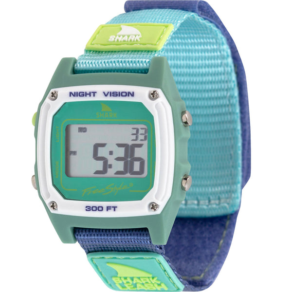 Freestyles Caroline Marks Signature Shark Classic Watch featuring a green-blue band, displays 5:36 PM with night vision and surf waterproof capabilities.