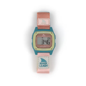 The Freestyle SHARK CLASSIC LEASH CABO is a digital watch featuring a pink strap, teal accents, and Surfin Safari style.