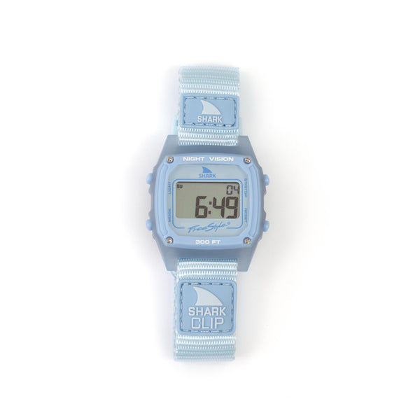 A Freestyle SHARK CLASSIC CLIP SKY digital surf watch with a light blue strap displays numbers on its screen.