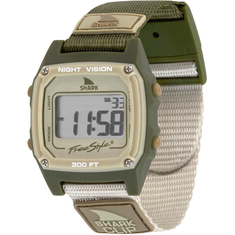 Freestyle SHARK CLASSIC CLIP ENSENADA digital surf watch with green/beige strap, display active with numerals and info visible.