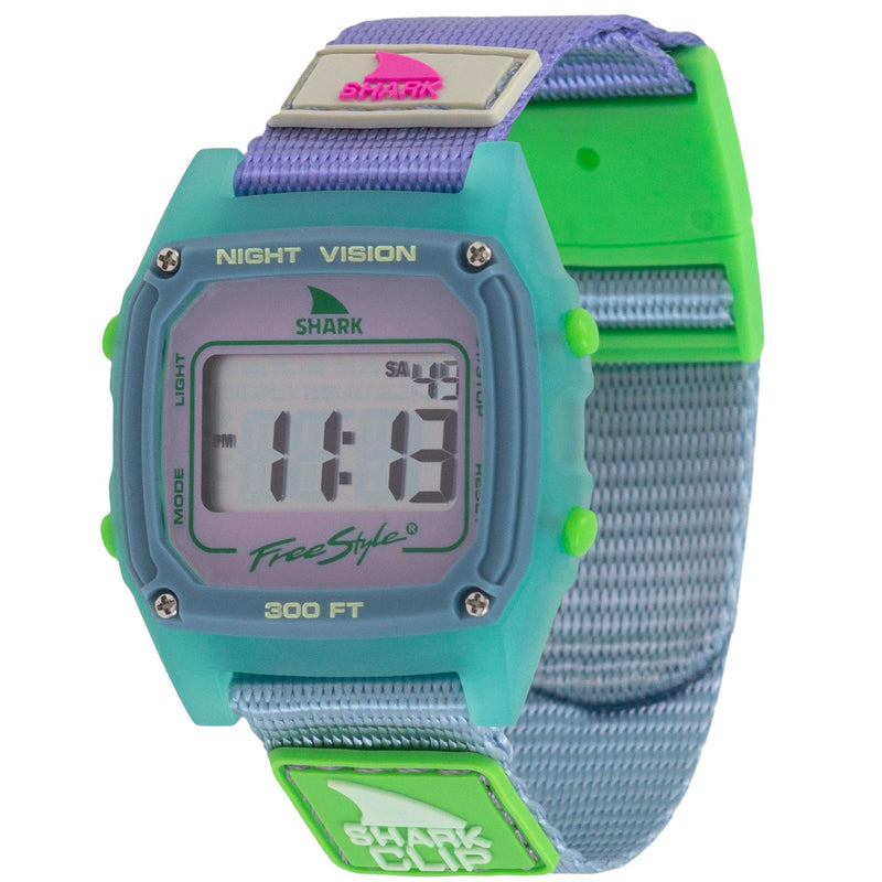 The Freestyle SHARK CLASSIC CLIP OCEANSIDE is a digital watch featuring a teal case, vibrant band, and coastal-inspired design.
