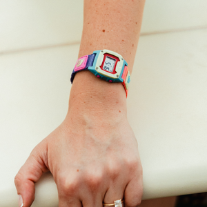Wearing the Freestyle SHARK MINI CLIP SEASCAPE, a blue, green, and pink watch, brings vibrant coastal vibes wherever you go.