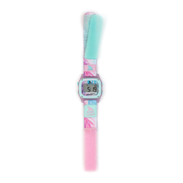 The SHARK CLASSIC LEASH BIMINI PALMS is a digital watch by Freestyle, featuring a pastel strap and a display with tropical-themed 5:19 graphics.