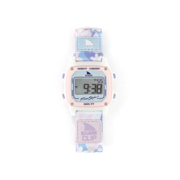 SHARK CLASSIC CLIP PERIWINKLE surf watch from Freestyle displaying 9:38 with a pastel floral strap and purple accents.