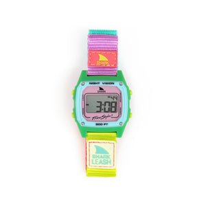 The Freestyle SHARK CLASSIC LEASH WATERMELON is a colorful digital watch with green case and multicolored strap, displaying numbers on the screen.