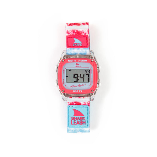 The Freestyle Caroline Marks Signature Shark Classic watch displays 9:47 with a vibrant red face and a multicolored strap, evoking the spirit of Surfin USA.
