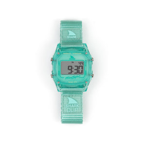 A Freestyle SHARK CLASSIC CLIP KIWI watch, turquoise, 100m water resistant, with display illuminated.