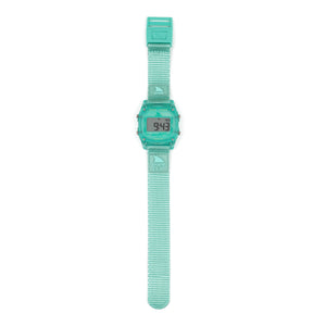 A Freestyle SHARK CLASSIC CLIP KIWI watch in teal, rectangular face, textured strap, 100m water resistant, digital display illuminated.