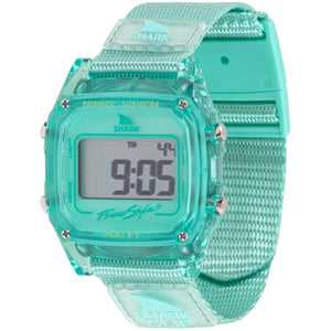 A Freestyle SHARK CLASSIC CLIP KIWI watch, water resistant to 100m, displays numbers on its digital screen.
