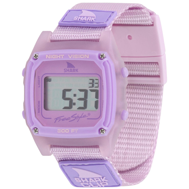 The Freestyle SHARK CLASSIC CLIP VIOLET displays numbers on its face and features a pastel purple nylon strap from the Sea Glass series.