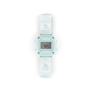 A Freestyle Shark Mini Leash Arctic Rush watch with a light blue fabric strap, display illuminated in white.
