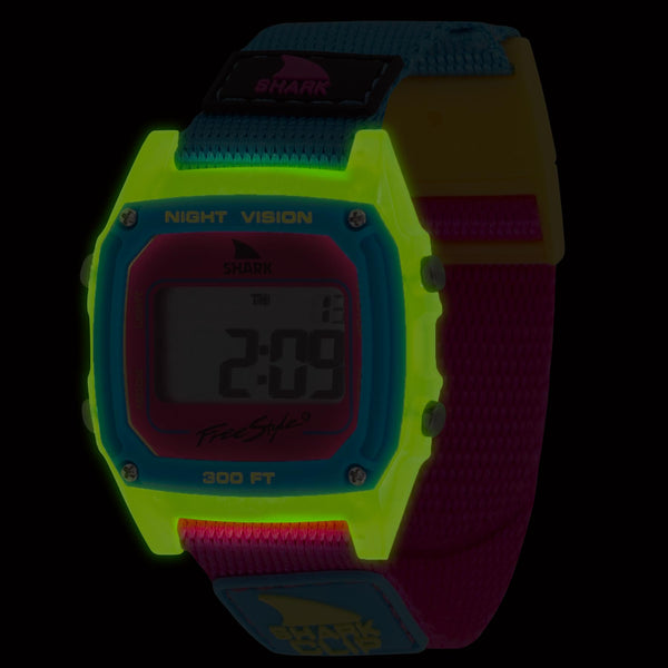 Freestyle SHARK CLASSIC CLIP LANTERN: A neon retro watch featuring Night Vision, Shark Brite technology, a multicolored strap, and a bright display.