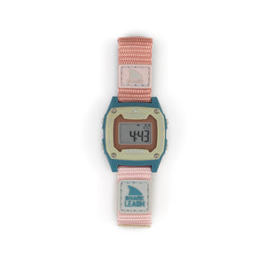 A Freestyle SHARK MINI LEASH CABO digital watch with a pink/teal band and rectangular display featuring digits.