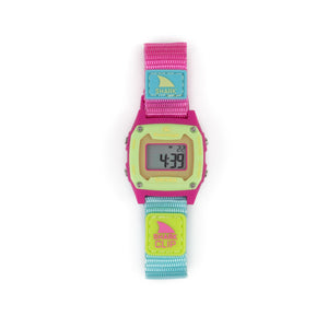 The Freestyle SHARK MINI CLIP POPSICLE watch with a pink, blue, and yellow strap displays numbers on its digital screen.