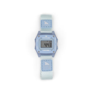 The Freestyle SHARK MINI CLIP SKY is a water-resistant digital watch with a light blue strap and face, displaying numbers on its screen.