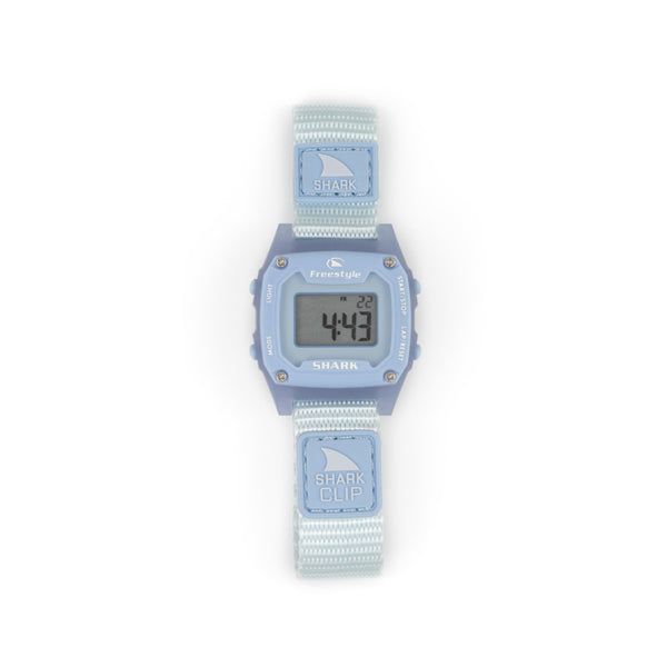 Freestyles SHARK MINI CLIP SKY watch in light blue with a rectangular face displaying 4:43 and Shark printed on the strap.