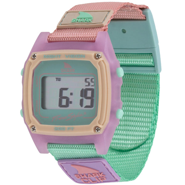 The Freestyle SHARK CLASSIC CLIP MELON MIX is a pastel digital watch with a square face and a pink, green, and beige strap.