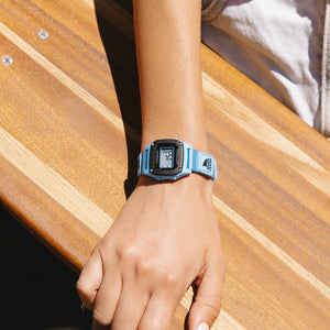 Person wearing a blue digital watch 