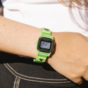 Person wearing a green digital watch 