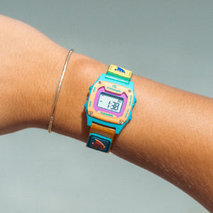 Colorful digital watch on a wrist with a plain background