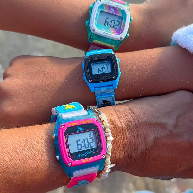 Three Shark watches at the shoreline