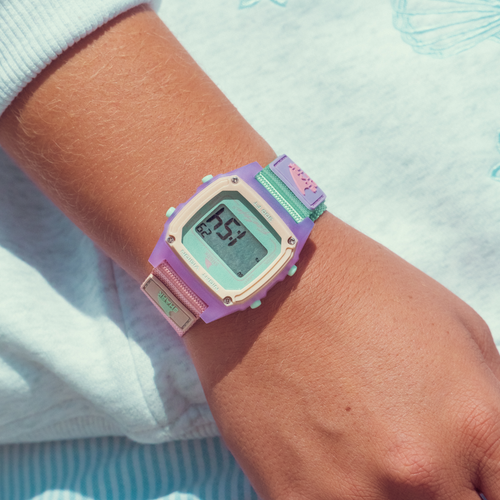 The Freestyle SHARK CLASSIC CLIP MELON MIX watch is worn on a wrist with a light long-sleeve shirt.