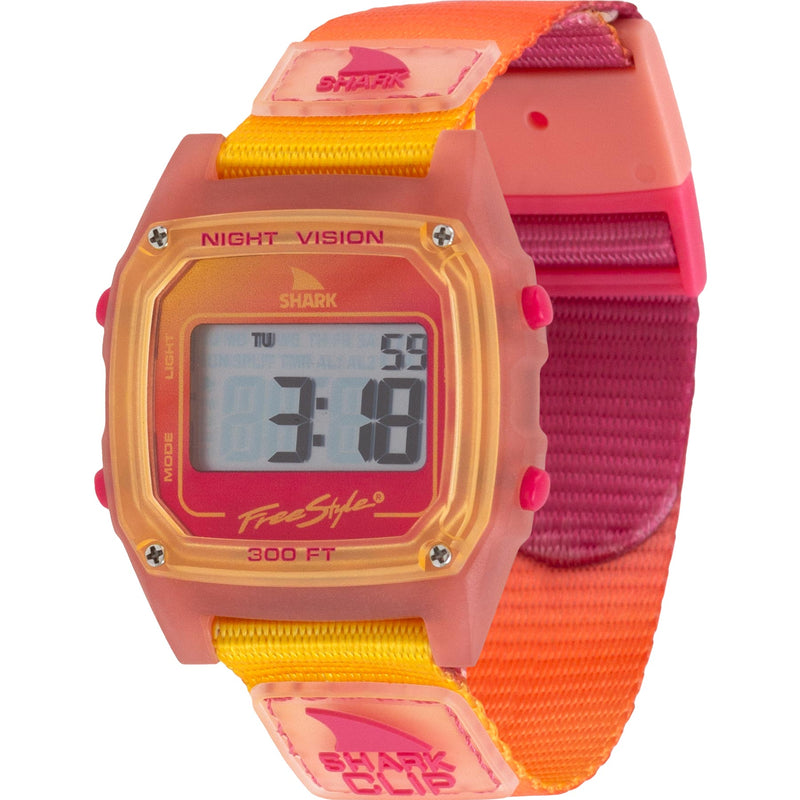 The Freestyle SHARK CLASSIC CLIP SUNSET features a retro square face, a pink-orange strap, and 300ft water resistance.