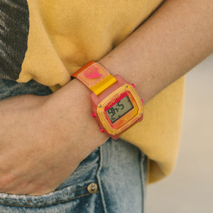 Wearing a Freestyle SHARK CLASSIC CLIP SUNSET watch with a pink/yellow strap and casual clothes.