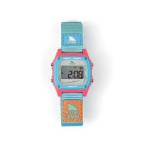 The Freestyle SHARK CLASSIC LEASH BEACH HOUSE watch features a pink and blue face with a blue strap—perfect for a fresh, vibrant look.