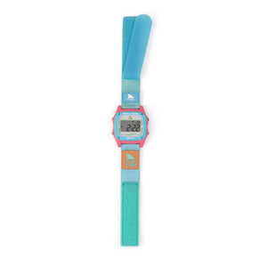 The Freestyle SHARK CLASSIC LEASH BEACH HOUSE has a blue/pink strap, velcro closure, water resistance, and a digital display.