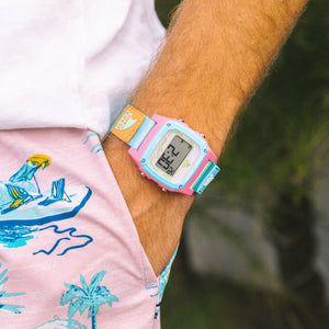 Wearing the Freestyle SHARK CLASSIC LEASH BEACH HOUSE watch in pastel pink and blue with beach-print pink shorts.