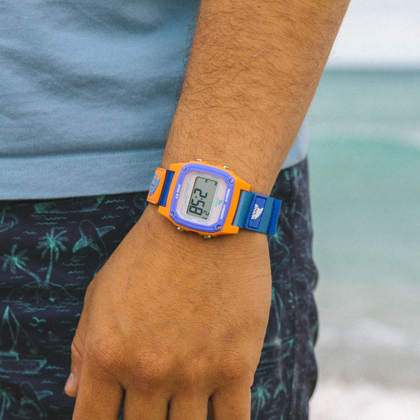 Freestyle Shark Classic Leash Shore Break watch on wrist with blue, purple, and orange strap, Shark Leash closure, and water resistance.