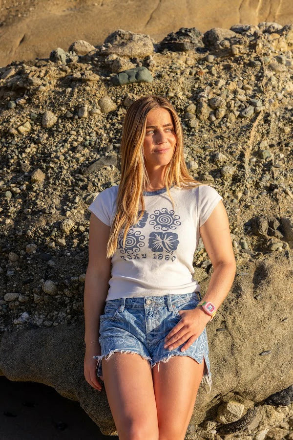 Caroline Marks on the rocks wearing Surfer Girl