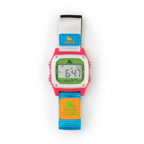 Freestyle SHARK CLASSIC LEASH SINCE 81 NEON 2.0 watch featuring a pink face, blue-gray straps, and vibrant patches.
