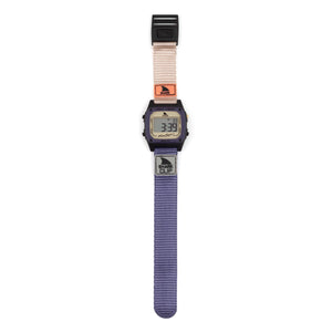 Freestyle SHARK CLASSIC CLIP INDIGO TAN digital watch featuring a beige upper strap, purple lower strap, and retro-style screen.