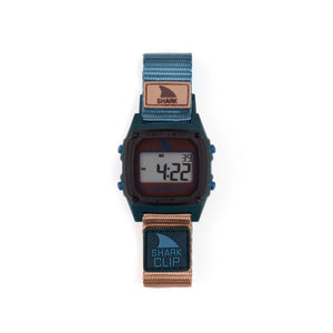 Freestyle SHARK CLASSIC CLIP SEA N SAND digital watch with blue/tan striped band displays numbers on its retro-futurist face.