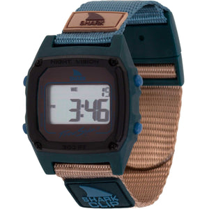 The Freestyle SHARK CLASSIC CLIP SEA N SAND displays a digital screen with a teal and tan strap in retro-futurism style.